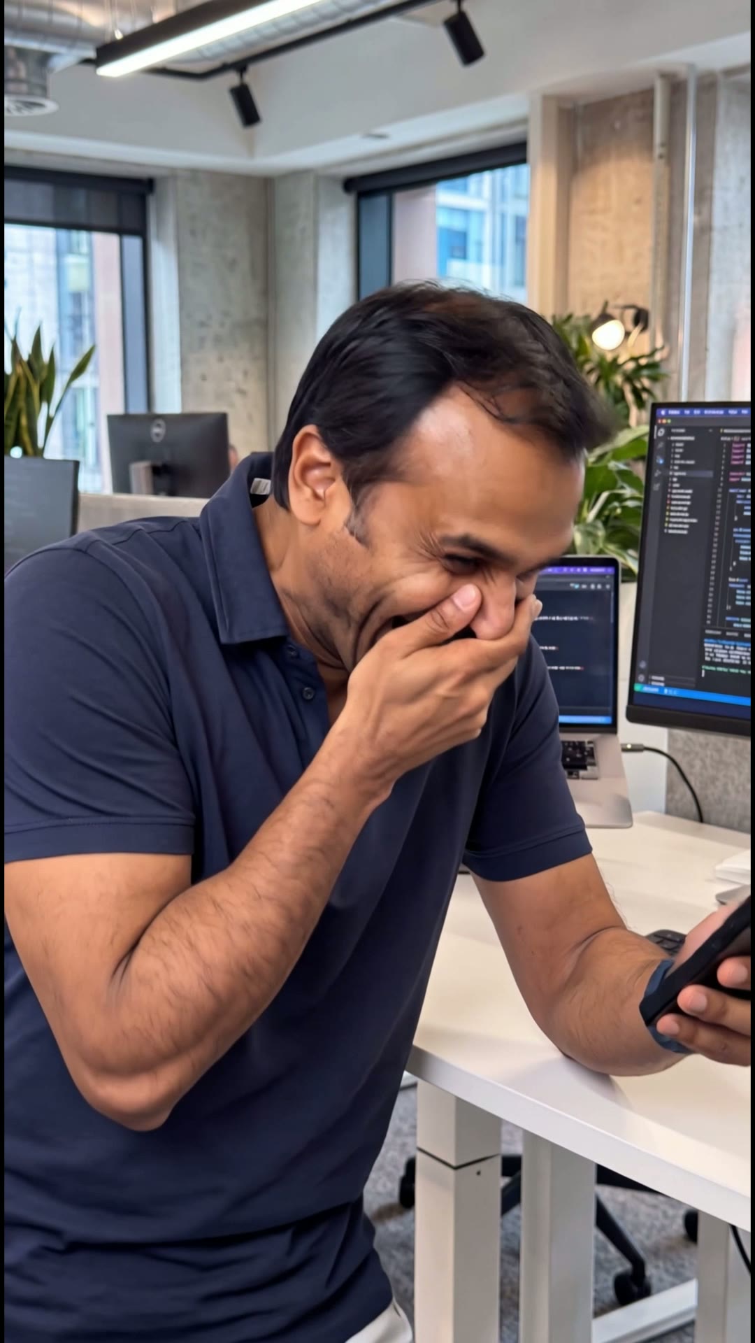 Amit Laughing at Phone — Vertical