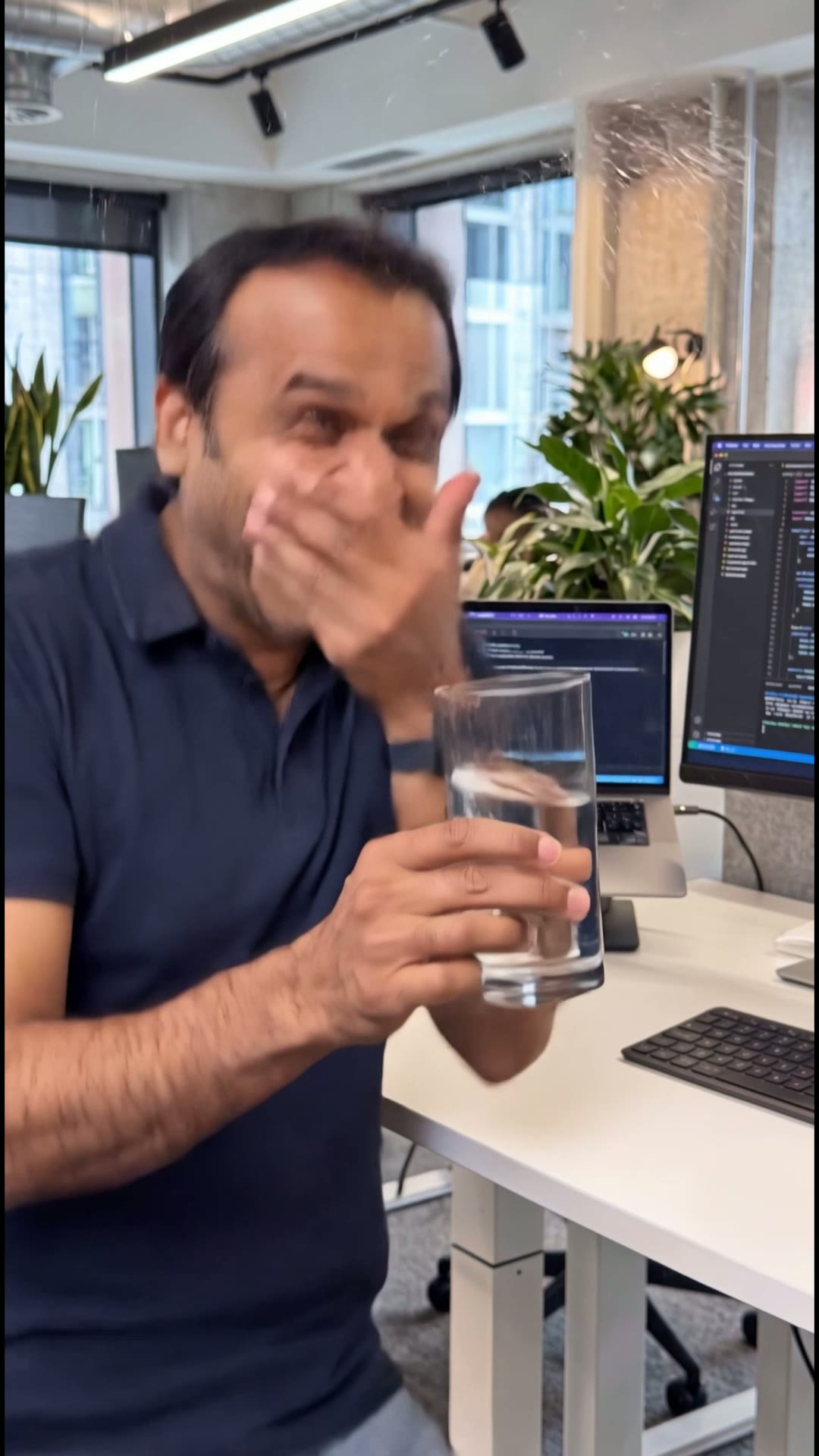 Amit Trying Not to Laugh With Water — Vertical